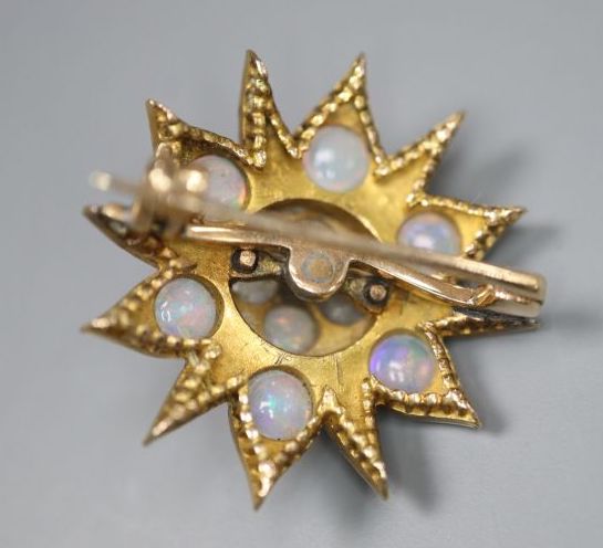 An Edwardian yellow metal, opal and diamond set flower head brooch, 25mm, gross 6.9 grams.